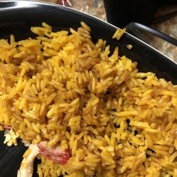 a plate of yellow rice and chicken a plate of yellow rice and chicken