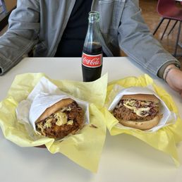 Nashville hot chicken sandwich and buttermilk chicken sandwich (I believe that's what they're called) with a Coke bottle Nashville hot chicken sandwich and buttermilk chicken sandwich (I believe that's what they're called) with a Coke bottle