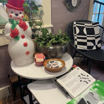Santa Cecilia - Winter snowman with masks, crossword, communal resources and other literature. - Cafes Near Me - Albuquerque, New Mexico