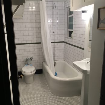 Appease Builders - The after photo: subway tile w/black grout, art deco accent line, ceiling mounted shower curtain track, new window, new cove base trim tile. - Plumbing Near Me - Long Beach, California