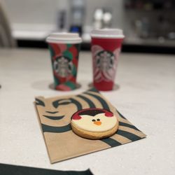 Starbucks - Holiday red cup vibes. Got my red cup and the Caramel Brûlée latte and a penguin sugar cookie