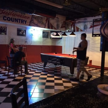 Golden Rooster - a man playing pool in a bar - Bars Near Me - Jacksonville, Florida