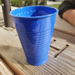 a blue cup on a table a blue cup on a table