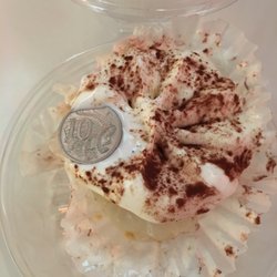 Frozen solid tiramisu. Like an ice puck. Tiny size for $6. 10 cent coin for scale.