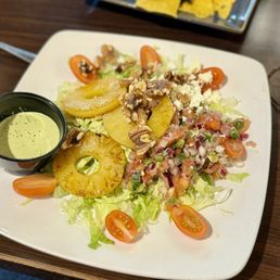 Tropical salad with grilled pineapple, walnuts, cucumber dressing