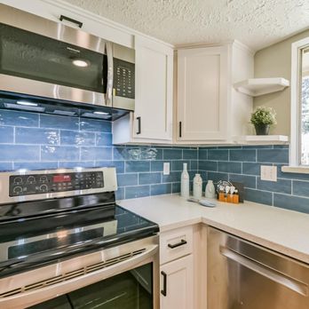 MG RENOVATION - a kitchen with a stove, microwave, and dishwasher - General Contractors Near Me