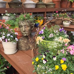 Sunnyfield Greenhouse & Nursery - Elegant blooming baskets fill the entryway to Sunnyfield's flowering greenhouse.