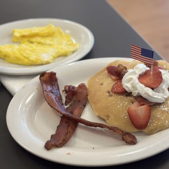 Eggs Up Grill - Red, White and Bacon Pancakes with a side of scrambled eggs. - Breakfast & Brunch Near Me - Hope Mills, North Carolina Eggs Up Grill - Red, White and Bacon Pancakes with a side of scrambled eggs. - Breakfast & Brunch Near Me - Hope Mills, North Carolina
