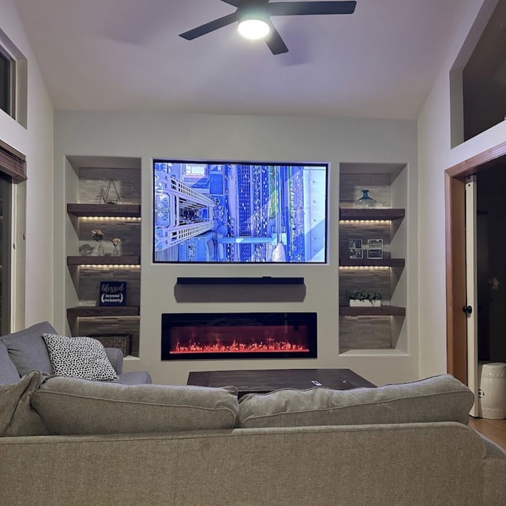 Sunrise Energy Solutions - The finished room! Stone wall accents, fancy fireplace, custom shelves and smart home lighting! - Solar Installation Near Me Sunrise Energy Solutions - The finished room! Stone wall accents, fancy fireplace, custom shelves and smart home lighting! - Solar Installation Near Me