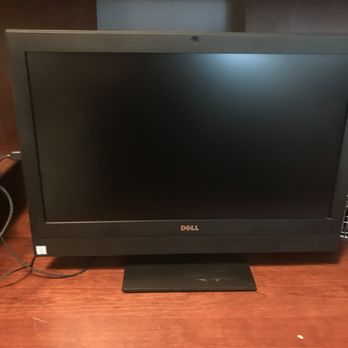 Computer-Tech-Services - Junk computer Greg sold me. Also makes me wonder if my original could have been fixed!  From Computer-Tech-Services. - A Dell computer monitor with a black screen is positioned on a wooden desk. The monitor has a rectangular shape with a black frame and a stand. Cables are visible on the left side of the monitor, and the background includes a wooden panel and a wall. The image appears to be taken indoors in an office or workspace setting. - IT Services & Computer Repair Near Me - Greenville, South Carolina