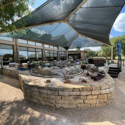 Mulligan's Restaurant - The sail shade protects the artwork - it's a replica of some of the City of Georgetown's iconic buildings with a train track.