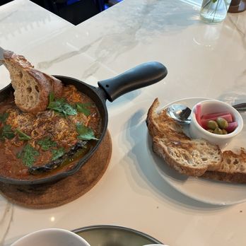 Ammatoli - Chef Dima's Shakshuka (Poached eggs, tomato stew, onions, peppers, garlic. Served with "Gusto" sourdough bread - $24) - Mediterranean Near Me - Long Beach, California