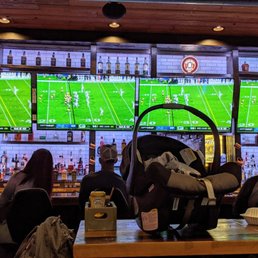 Watching the game at the bar on consecutive screens. It's a family place.