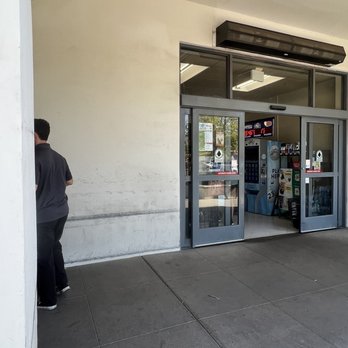 Bashas' -  a man standing in front of a store - Grocery Near Me - Buckeye, Arizona