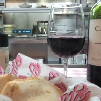 Buca di Beppo Italian Restaurant - A slightly posed set up of our wine and bread while we watched the kitchen prepare our dinner - Italian Near Me - Lombard, Illinois Buca di Beppo Italian Restaurant - A slightly posed set up of our wine and bread while we watched the kitchen prepare our dinner - Italian Near Me - Lombard, Illinois