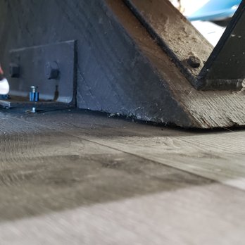 Green Renovation Group - after replacing the flooring, there was a 1/4" gap below the support beam for the stairs, held up by only this one little nail. - General Contractors Near Me - Sherman Oaks, California