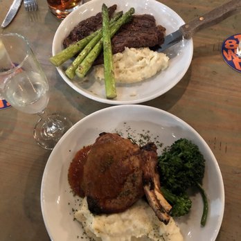 District Market - Pork chop (close) and ribeye (far) - New American Near Me - Houston, Texas District Market - Pork chop (close) and ribeye (far) - New American Near Me - Houston, Texas