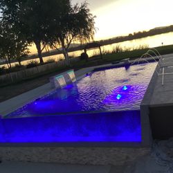 Kustom Pools & Landscaping - Plaster pool with infinity edge, lights, boublers, deck jets, sheer decents and diving board.