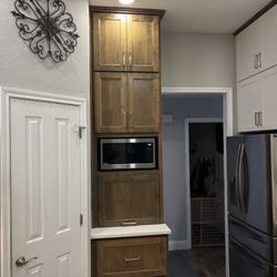 Custom cabinets with equipment garage and microwave cubby