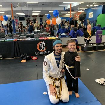 Ultimate Martial Arts - Christian with instructor Jordan at belt graduation - Kickboxing Near Me - Fresno, California Ultimate Martial Arts - Christian with instructor Jordan at belt graduation - Kickboxing Near Me - Fresno, California