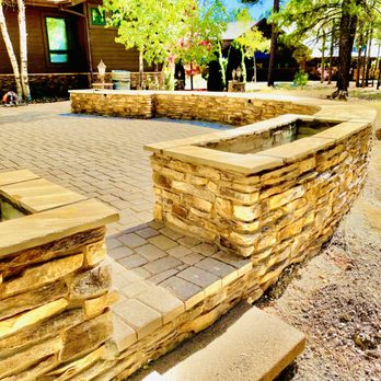 Apex Landscape - a stone wall with a water feature - Landscape Architects or Designers Near Me Apex Landscape - a stone wall with a water feature - Landscape Architects or Designers Near Me