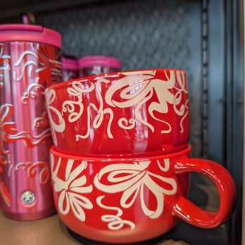 Starbucks - red mugs on a shelf in a coffee shop - Coffee & Tea Near Me - Seattle, Washington Starbucks - red mugs on a shelf in a coffee shop - Coffee & Tea Near Me - Seattle, Washington