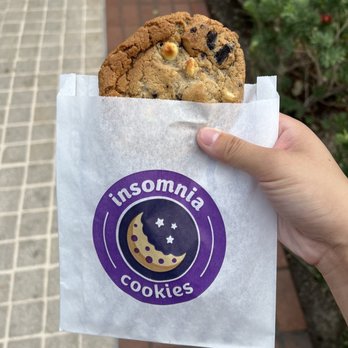 Insomnia Cookies - a hand holding a cookie - Desserts Near Me - Los Angeles, California Insomnia Cookies - a hand holding a cookie - Desserts Near Me - Los Angeles, California