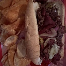 Philly cheesesteak sandwich that is made with pastrami and prime rib