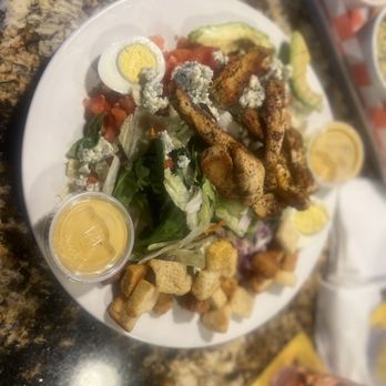 Moochies Tavern - Blackened Chicken salad (added croutons and red onions) with house made honey mustard SO good and big! It was 3 meals for me! - Burgers Near Me - Matthews, North Carolina Moochies Tavern - Blackened Chicken salad (added croutons and red onions) with house made honey mustard SO good and big! It was 3 meals for me! - Burgers Near Me - Matthews, North Carolina