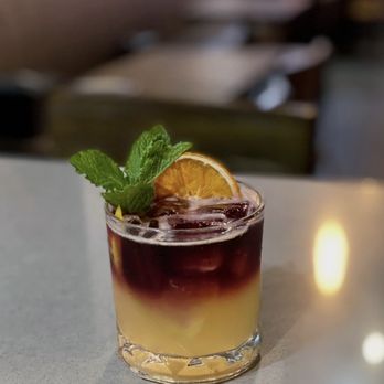 Poseidon Boil - a drink with a garnish on top - Cocktail Bars Near Me - Henrico, Virginia