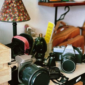 interim coffee - a table with cameras and a lamp - Coffee & Tea Near Me - Carlsbad, California interim coffee - a table with cameras and a lamp - Coffee & Tea Near Me - Carlsbad, California