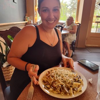 Oliver’s - a woman sitting at a table with a plate of pasta - Salad Near Me - Ste. Genevieve, Missouri Oliver’s - a woman sitting at a table with a plate of pasta - Salad Near Me - Ste. Genevieve, Missouri