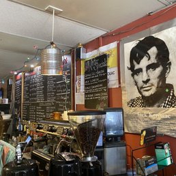 a man behind a coffee machine a man behind a coffee machine