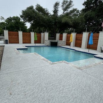 Cody Pools - Georgetown - Pool, cool deck, privacy wall, umbrellas, and grotto - General Contractors Near Me - Georgetown, Texas