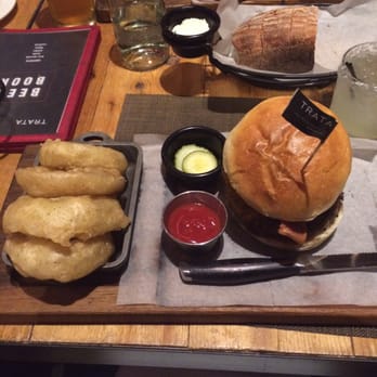Trata - Sexy TRATA burger, onion rings, and duck quesadilla in the background! - New American Near Me - Rochester, New York