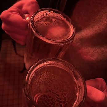 Bernie's - two people holding glasses of beer - New American Near Me - Brooklyn, New York