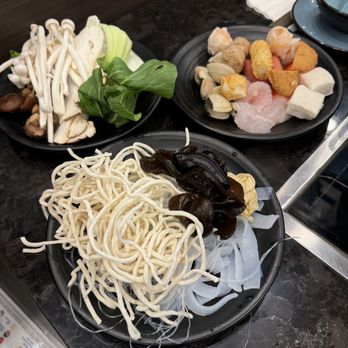 Happy Lamb Hot Pot - From the bar style. Got my various noodles, veggies, and fish balls. - Chinese Near Me - Dublin, California