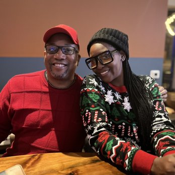 Congress Social Bar - a man and woman sitting at a table - Bars Near Me - Durham, North Carolina