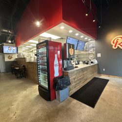 Little Rosa's Pizza - Front entryway w kitchen window & dining.