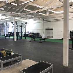 Speed Power Strength Gym - View of the long turf- 30 yards- and weight lifting rig for the Crossfit area. Medicine balls, dumbbells and kettlebells
