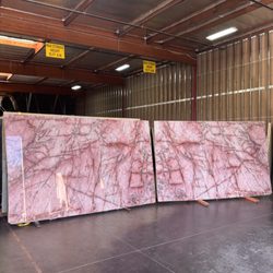 Legacy Stone & Marble - Translucent Cosmopolitan Quartzite featuring soft blush tones, crystalline depth, and rich burgundy veining that comes alive when backlit.
