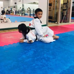 Chin Woo Quan Tae Kwon Do Academy - Siblings helping each other on their flexibility