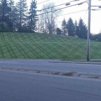 Tender Lawn Care - a green hill with a sign on it - Masonry/Concrete Near Me - Brewer, Maine Tender Lawn Care - a green hill with a sign on it - Masonry/Concrete Near Me - Brewer, Maine