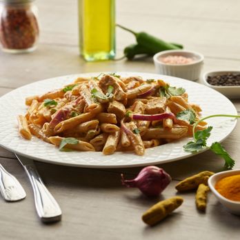 Pizza Twist - a plate of pasta with meat and vegetables - Pizza Near Me - Murphy, Texas