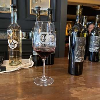 Saarloos & Sons - a glass of wine and bottles of wine - Wineries Near Me - Los Olivos, California