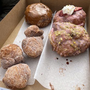 Parlor Doughnuts - Bourbon caramel, strawberry cheesecake, raspberry pistachio, turtle cheesecake (missing - already being devoured), and donut holes! - Donuts Near Me - Oceanside, California