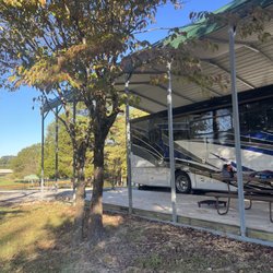 Parkers Crossroads RV Park & Campground - Covered site w/full hook-ups. Picnic table near lake/pond, very well kept. Had our 2 dogs that loved the area.