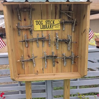The 828 - Dog stick library in foreground outside eating behind - Beer Bar Near Me - Lake Lure, North Carolina