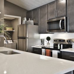 Mallard Landing - Spacious kitchen with 42" custom cabinetry, white quartz countertops, subway tile backsplash and stainless-steel appliances.