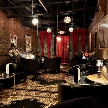 Vinifera - a living room with black furniture and red drapes - Beer, Wine & Spirits Near Me - Geneva, New York